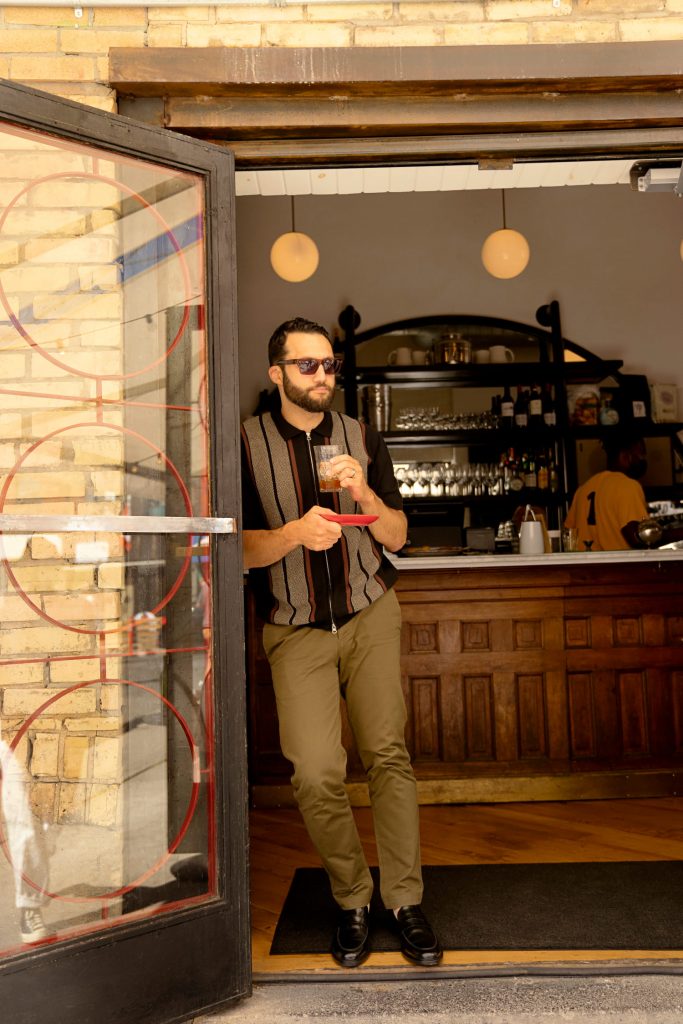 Daniel Habashi leans against the doorway to Manita, a restaurant in Toronto.