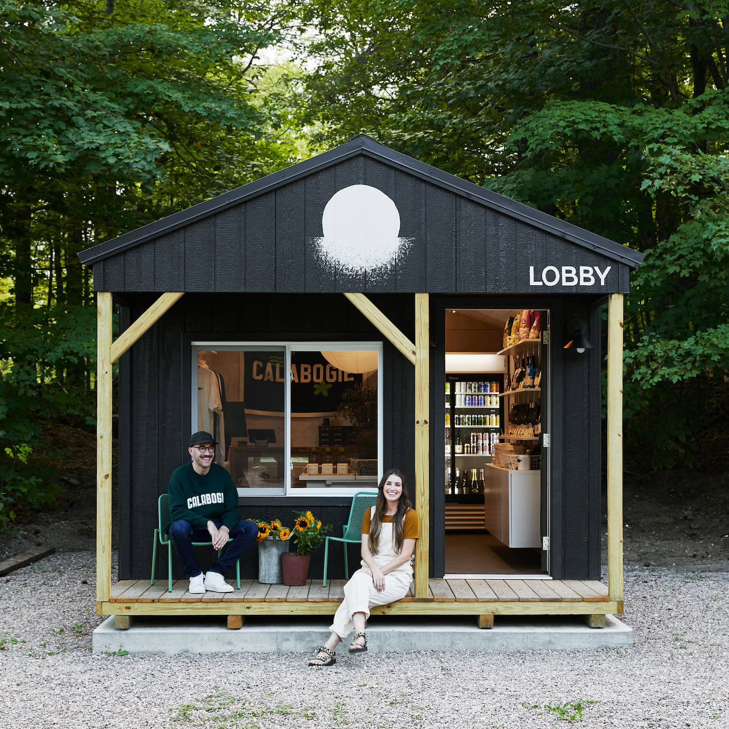 Joel Greaves and Devon Vaillancourt sit outside the lobby/gift shop of their new motel , Somewhere Inn Calabogie